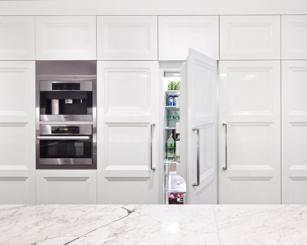 Fridge hidden withing the cabinetry to increase small kitchen space